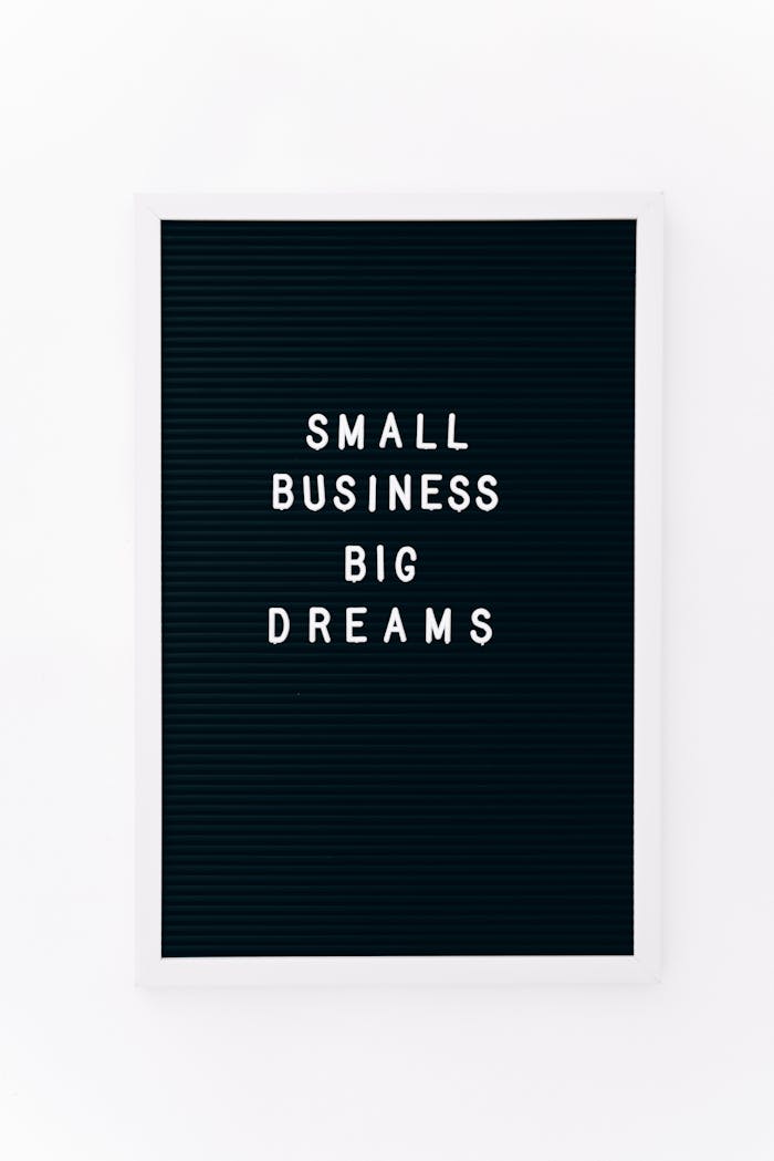Black letterboard with Small Business Big Dreams text promoting entrepreneurship.