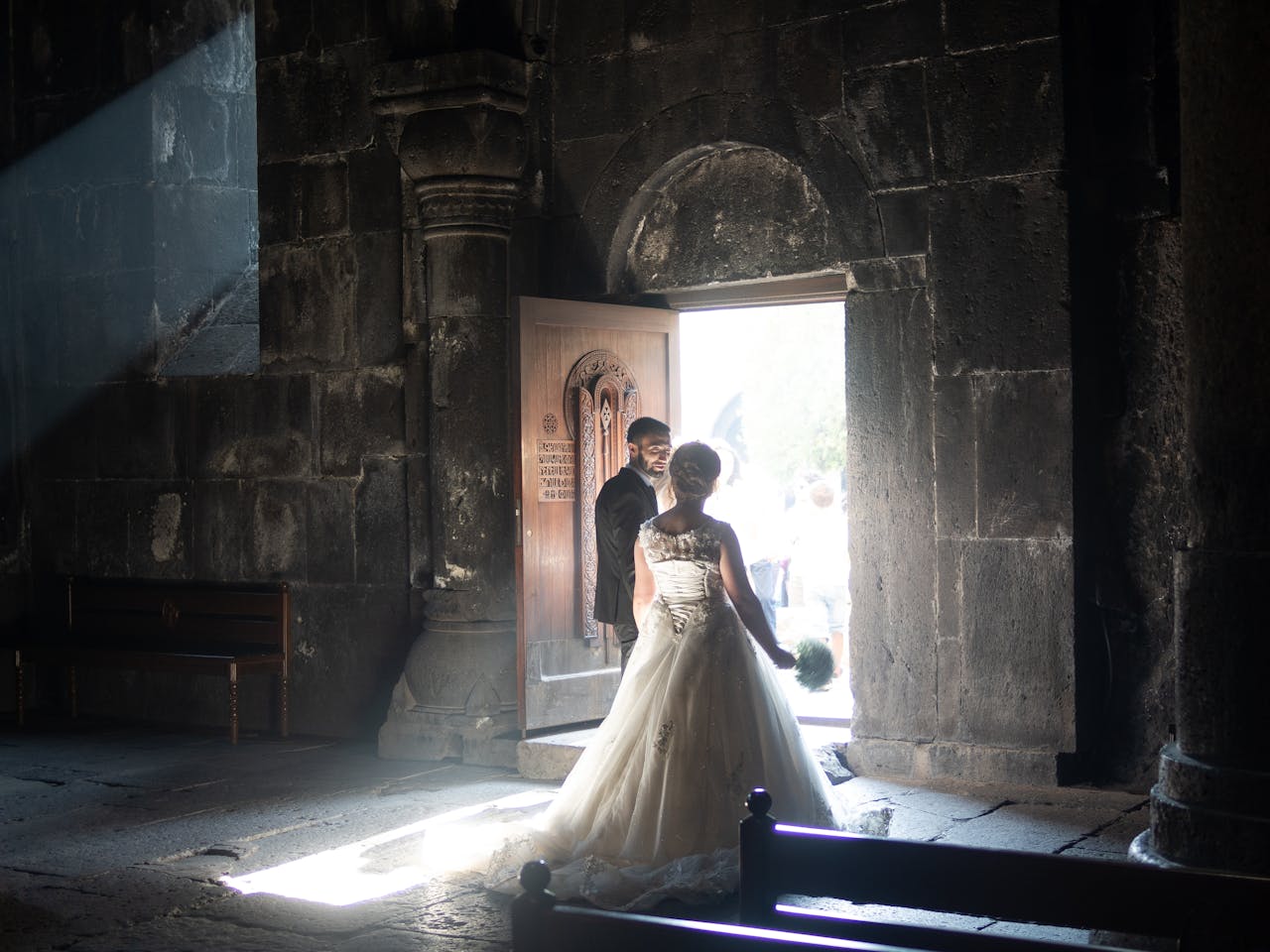 Bride and groom captured in beautiful lighting in a historic church setting.